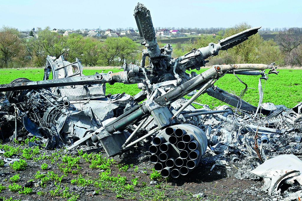 KHARKIV: The wreckage of a downed Russian helicopter lies in a field near Kharkiv on April 16, 2022, amid the Russian invasion of Ukraine. Russia has stepped up air strikes on Kyiv, hitting another military factory a day after Moscow warned it would renew attacks following two weeks of relative calm in the Ukrainian capital. - AFP