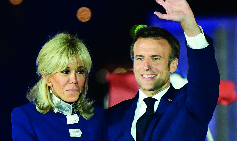 PARIS: French President and La Republique en Marche (LREM) party candidate for re-election Emmanuel Macron and his wife Brigitte Macron celebrate after his victory in France's presidential election on April 24, 2022.- AFP