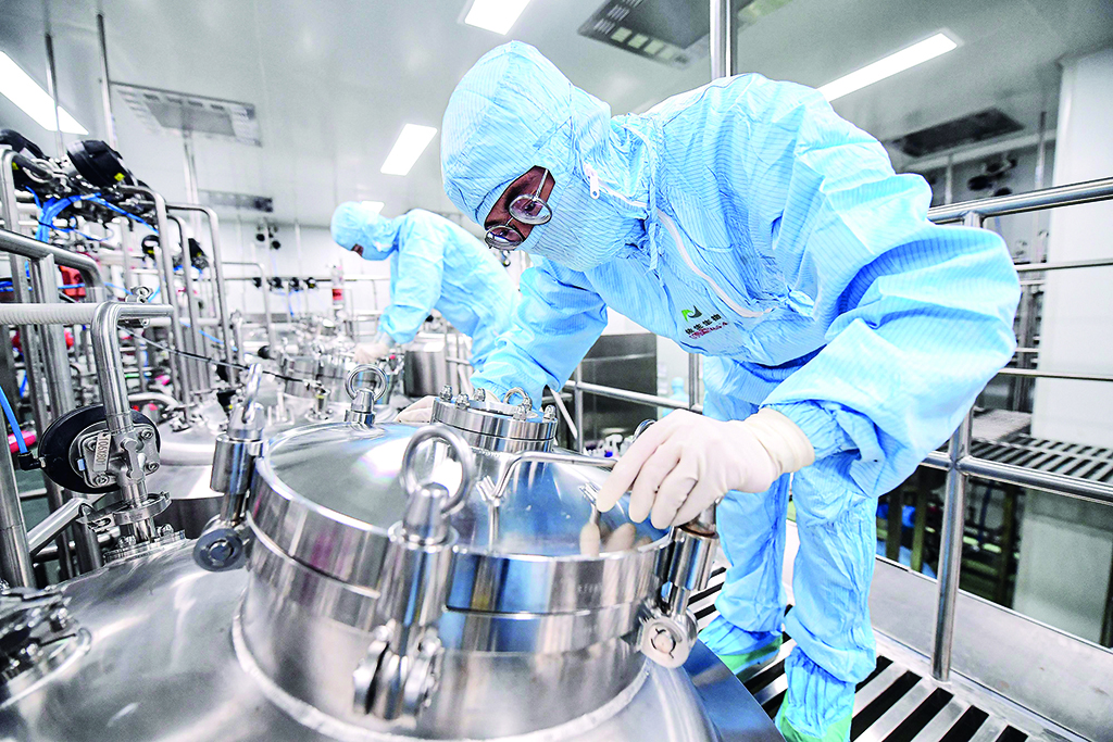 SHENYANG: An employee works at a facility producing a COVID-19 coronavirus vaccine, which is currently undergoing clinical tests, in Shenyang in China's northeastern Liaoning province.- AFP