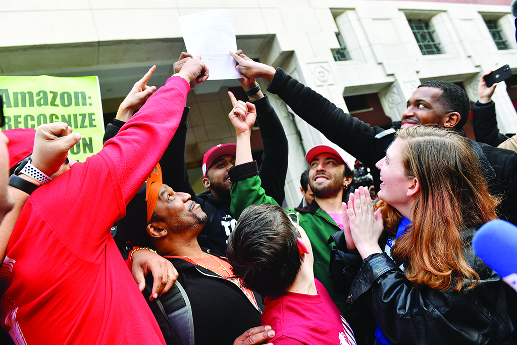 NEW YORK: Union organizer Christian Smalls (left) celebrates with Amazon workers following the April 1, 2022, vote for the unionization of the Amazon Staten Island warehouse in New York. - AFP