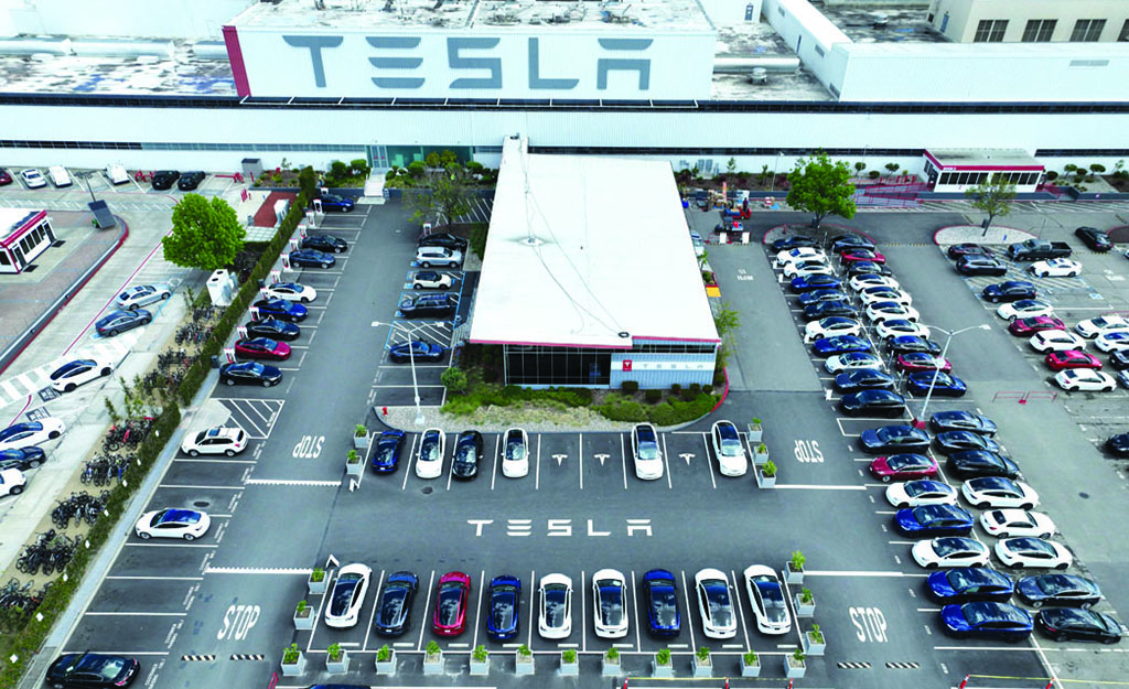 FREMONT: In an aerial view, Tesla cars sit parked in a lot at the Tesla factory on April 20, 2022 in Fremont, California. - AFP