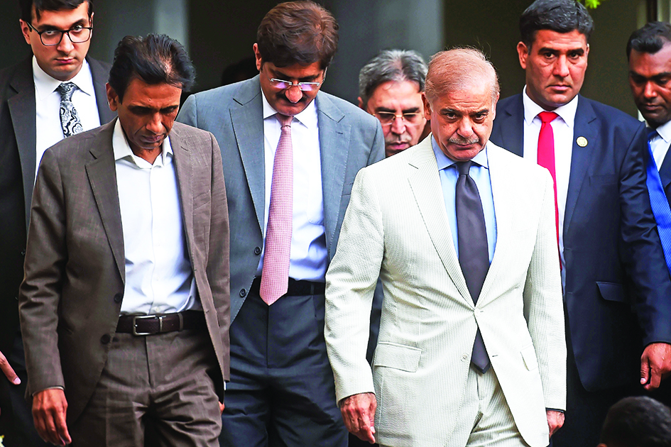 LAHORE:Pakistan's Prime Minister Shehbaz Sharif (second right) and leader of the Muttahida Qaumi Movement (MQM-P) and collation partners of the newly formed government Khalid Maqbool Siddiqui (left) leave after a meeting in Karachi on April 13, 2022. - AFP