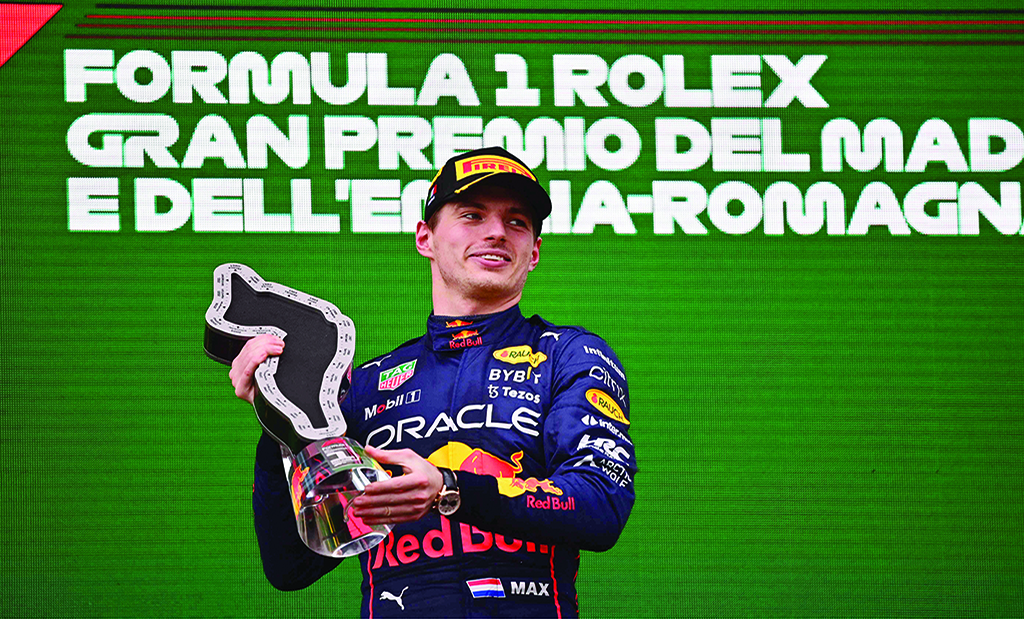IMOLA, Italy: Red Bull Racing's Dutch driver Max Verstappen holds the winner's trophy as he celebrates on the podium after the Emilia Romagna Formula One Grand Prix at the Autodromo Internazionale Enzo e Dino Ferrari race track on April 24, 2022. - AFP