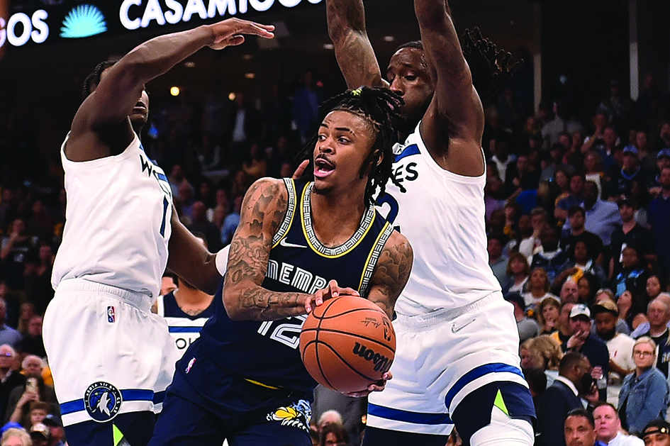MEMPHIS, Tennessee: Ja Morant #12 of the Memphis Grizzlies looks to pass against Anthony Edwards #1 and Taurean Prince #12 of the Minnesota Timberwolves during Game Five of the Western Conference First Round NBA Playoffs at FedExForum on April 26, 2022. – AFP