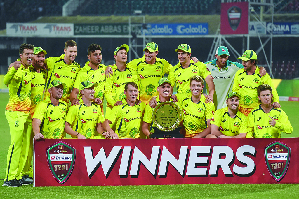 LAHORE: Australia's players pose with the trophy after winning a Twenty20 international cricket match between Pakistan and Australia at the Gaddafi Cricket Stadium on April 5, 2022. - AFP