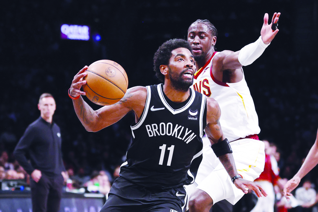 NEW YORK: Kyrie Irving #11 of the Brooklyn Nets dribbles as Caris LeVert #3 of the Cleveland Cavaliers defends during the first half of the Eastern Conference 2022 Play-In Tournament at Barclays Center on April 12, 2022. - AFP