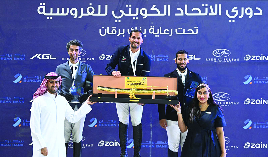 KUWAIT: Kuwait Sports Club jockey Ali Jassem Al-Kharafi receives the Kuwait Equestrian League trophy.