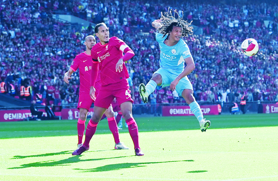 LONDON: Manchester City's Dutch defender Nathan Ake heads the ball next to Liverpool's Dutch defender Virgil van Dijk during their English FA Cup semifinal match at Wembley Stadium on April 16, 2022. - AFP