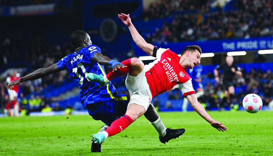 LONDON: Arsenal's German-born Portuguese defender Cedric Soares vies with Chelsea's French defender Malang Sarr during their English Premier League match at Stamford Bridge on April 20, 2022. - AFP