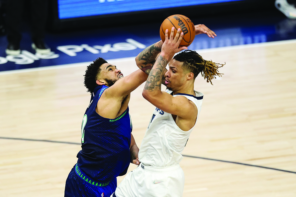 MINNEAPOLIS: Brandon Clarke #15 of the Memphis Grizzlies goes up for a shot while Karl-Anthony Towns #32 of the Minnesota Timberwolves defends in the third quarter during Game Six of the Western Conference First Round at Target Center on April 29, 2022. - AFP