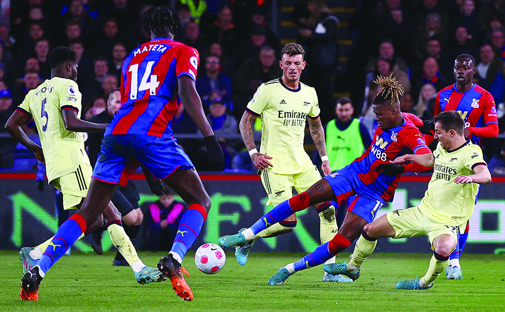 LONDON: Arsenal's German-born Portuguese defender Cedric Soares vies with Crystal Palace's Ivorian striker Wilfried Zaha during their English Premier League at Selhurst Park on April 4, 2022. - AFP