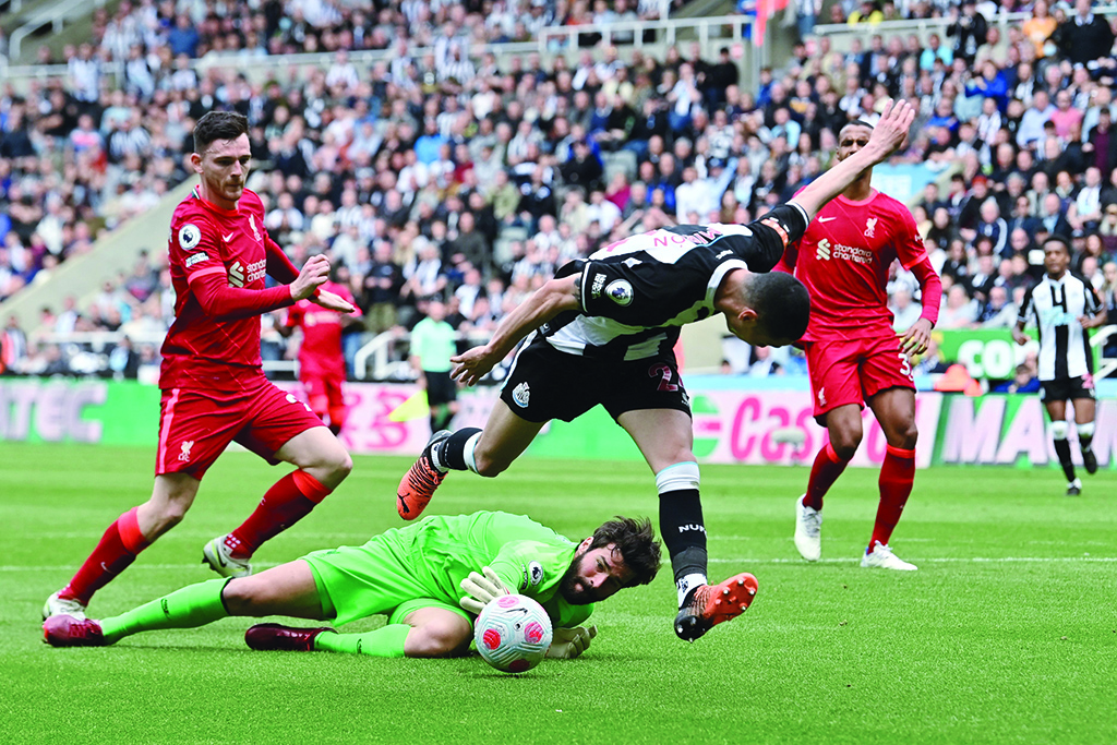 NEWCASTLE: Newcastle United's Paraguayan midfielder Miguel Almiron controls the ball past Liverpool's Brazilian goalkeeper Alisson Becker and scores, but the goal was cancelled due to an offside position, during their English Premier League match at St James' Park on April 30, 2022. - AFP
