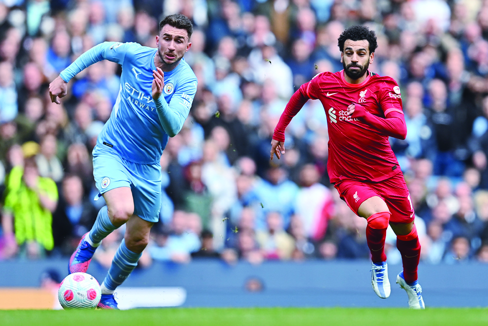 MANCHESTER: Liverpool's Egyptian midfielder Mohamed Salah vies with Manchester City's French defender Aymeric Laporte during their English Premier League match at the Etihad Stadium on April 10, 2022. - AFP