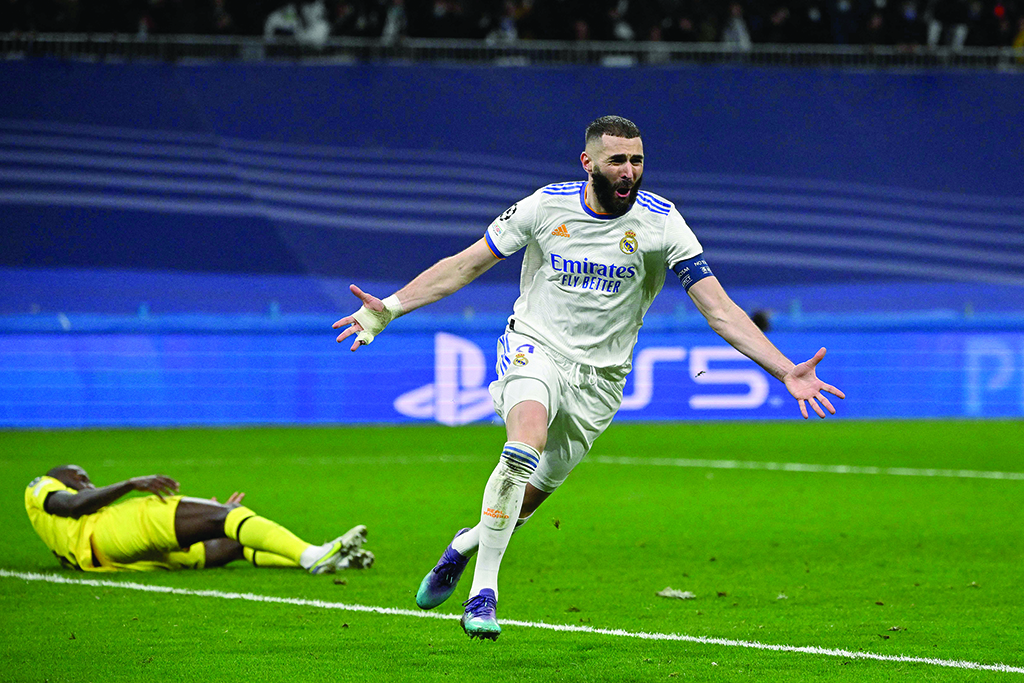 MADRID: Real Madrid's French forward Karim Benzema celebrates after scoring a goal during the UEFA Champions League quarterfinal second leg match between Real Madrid and Chelsea at the Santiago Bernabeu stadium on April 12, 2022. – AFP