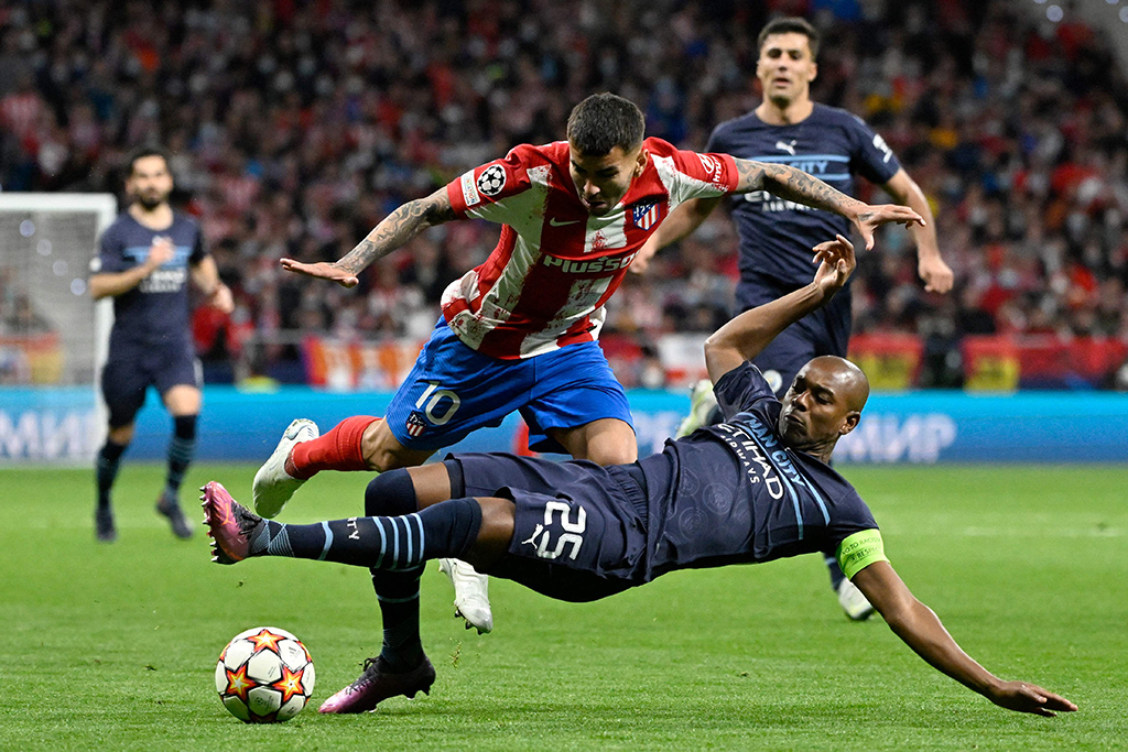 MADRID: Atletico Madrid's Argentinean forward Angel Correa (TOP) vies with Manchester City's Brazilian midfielder Fernandinho during the UEFA Champions League quarter final second leg football match between Club Atletico de Madrid and Manchester City FC on April 13, 2022. - AFP