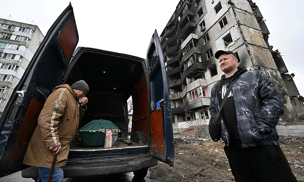 BORODIANKA: A man cries near a minivan with the coffin of his son, who died in the nearby building when it collapsed following a Russian air strike, on April 21, 2022 prior to the funeral ceremony in the small Ukrainian town of Borodianka.- AFP