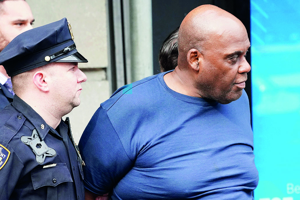 NEW YORK: Frank R James, 62, is led away from the 9th Precinct into Federal Custody in New York City after he was arrested on the Lower East Side in Manhattan by two patrol officers. - AFP