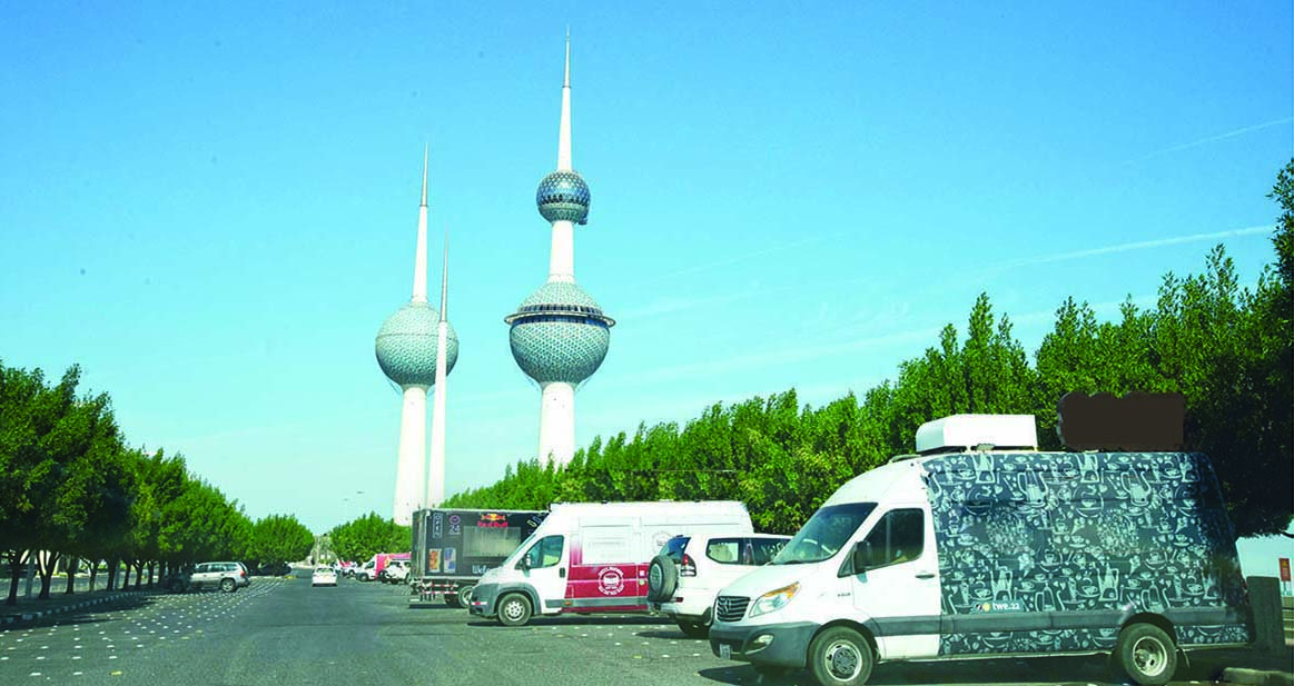 KUWAIT: This file photo shows food trucks parked on the seaside near Kuwait Towers. ¨C Photos by Fouad Al-Shaikh