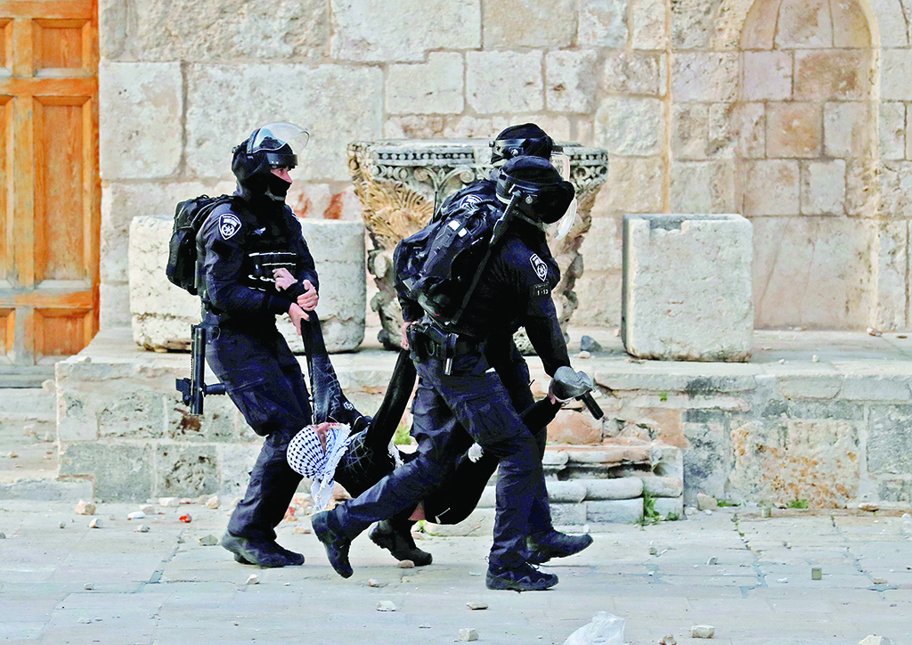 JERUSALEM: Zionist police arrest a Palestinian man at Jerusalem's Al-Aqsa Mosque on April 22, 2022. - AFP