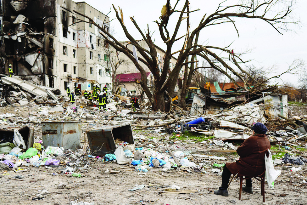 BORODIANKA: Antonina Kaletnyk waits for the body of her son in front of a collapsed building in the town of Borodianka, northwest of Kyiv, on April 8, 2022. - AFP