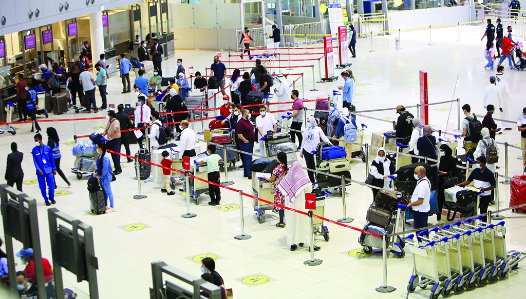 KUWAIT: This July 15, 2021 file photo shows travelers lined up to board their flights while adhering to COVID-19 restrictions at Kuwait International Airport. - Photo by Yasser Al-Zayyat