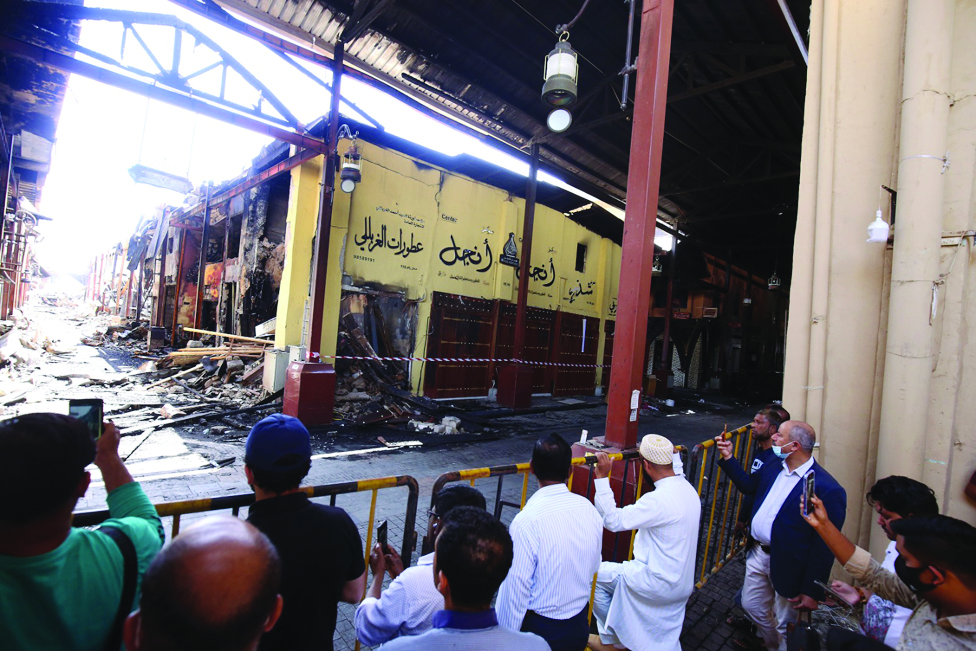 KUWAIT: People gather to see the damage caused by a fire that broke out in Souq Mubarakiya. - Photos by Yasser Al-Zayyat