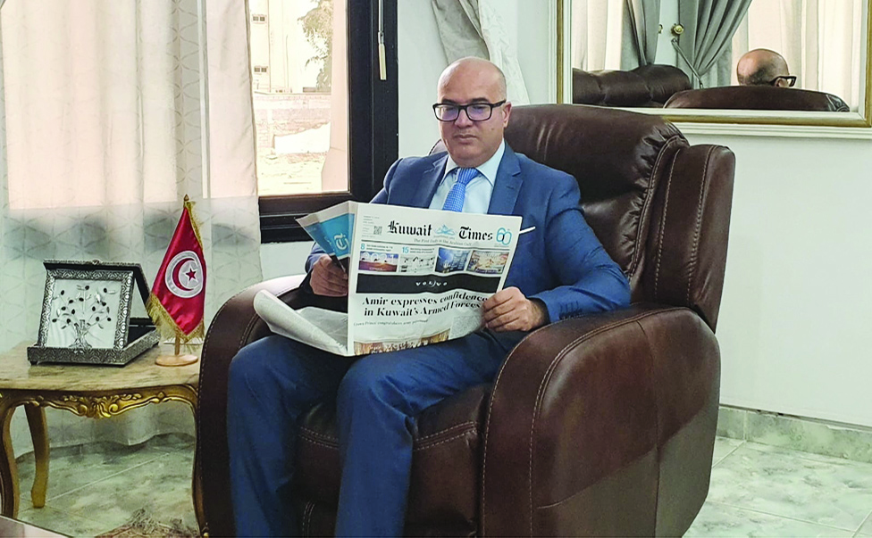 Tunisian Ambassador to Kuwait Hashemi Ajili reads Kuwait Times.