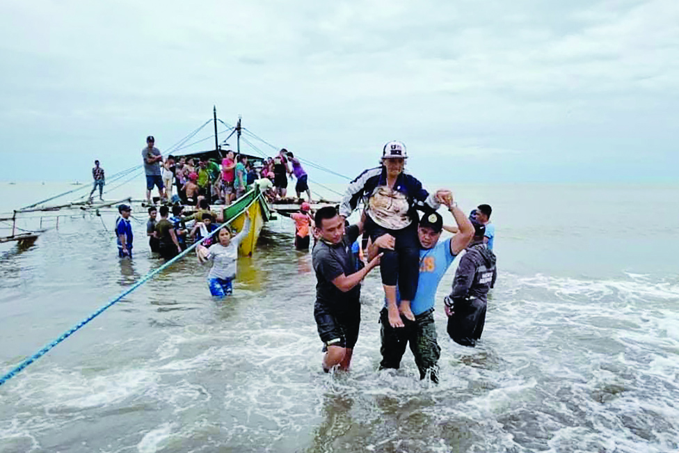 ABUYOG, Philippines: This undated handout photo received from 14TH IB (Avenger Battalion) Philippine Army on April 13, 2022 shows Pilar Village residents being evacuated on boat to the town of Abuyog after their village were struck by landslide. – AFP
