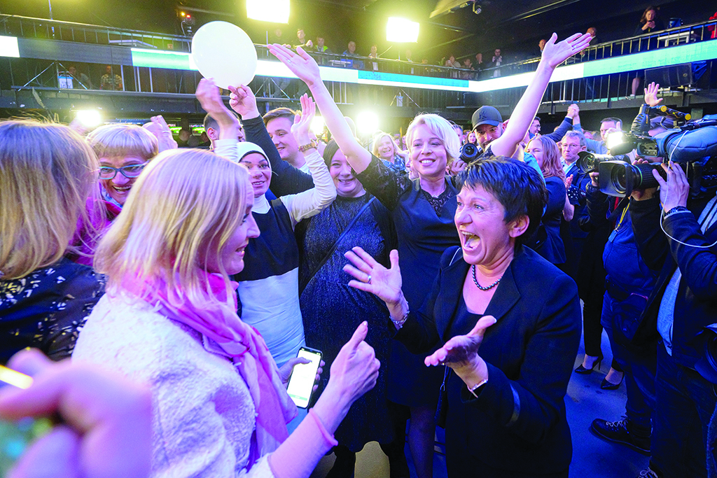 LJUBLJANA, Slovenia: Members of the liberal Freedom Movement party (Gibanje Svoboda) celebrate after exit poll results give them the victory in Slovenia's parliamentary elections, in Ljubljana. - AFP