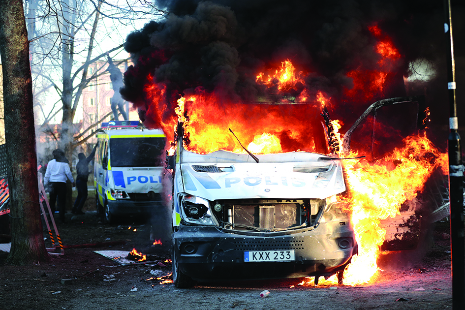 STOCKHOLM, Sweden: Police vans are on fire during a counter-protest in the park Sveaparken in Orebro, south-centre Sweden, where Danish far-right party Stram Kurs had permission for a square meeting on Good Friday. – AFP