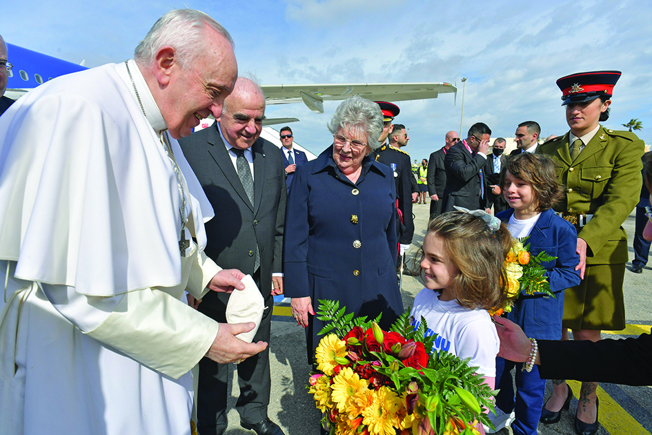 LUQA, Malta: Photo shows children offering flowers to Pope Francis (L) as Malta's President, George Vella (2ndL) and his wife Miriam Vella (C) look on, after the Pope landed at Malta's international airport in Luqa, for a two-day trip to the island. – AFP