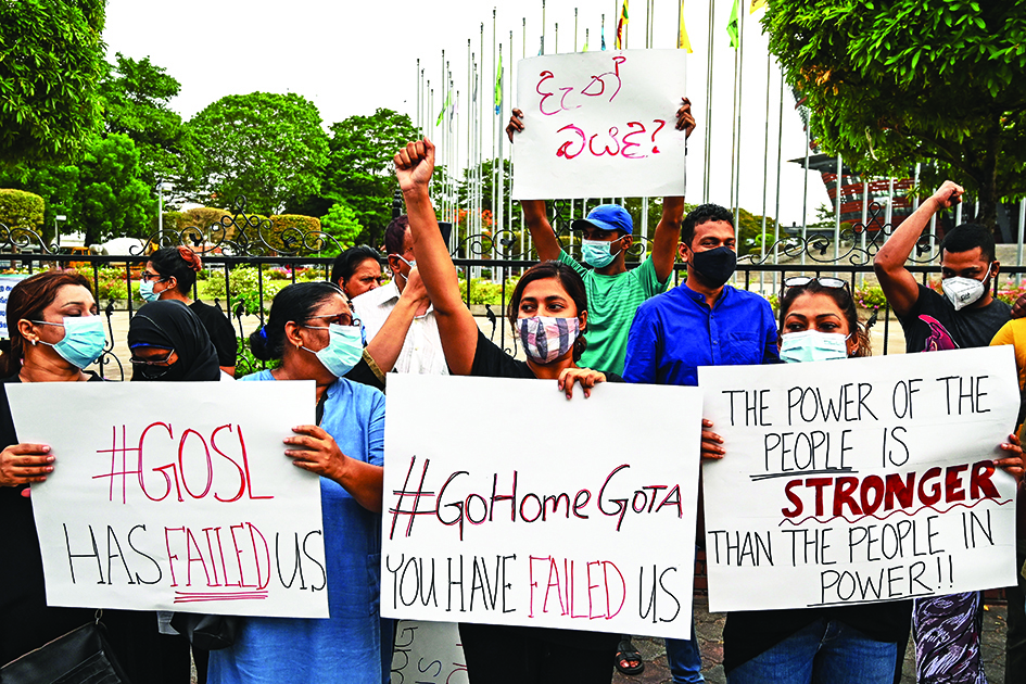 COLOMBO: Protestors hold banners and placards during a demonstration against the surge in prices and shortage of fuel and other essential commodities in Colombo on April 2, 2022. – AFP