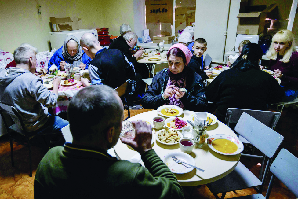 DNIPRO: People displaced by the war in Ukraine eat lunch at a former maternity hospital turned shelter for internally displaced people in Dnipro. - AFP