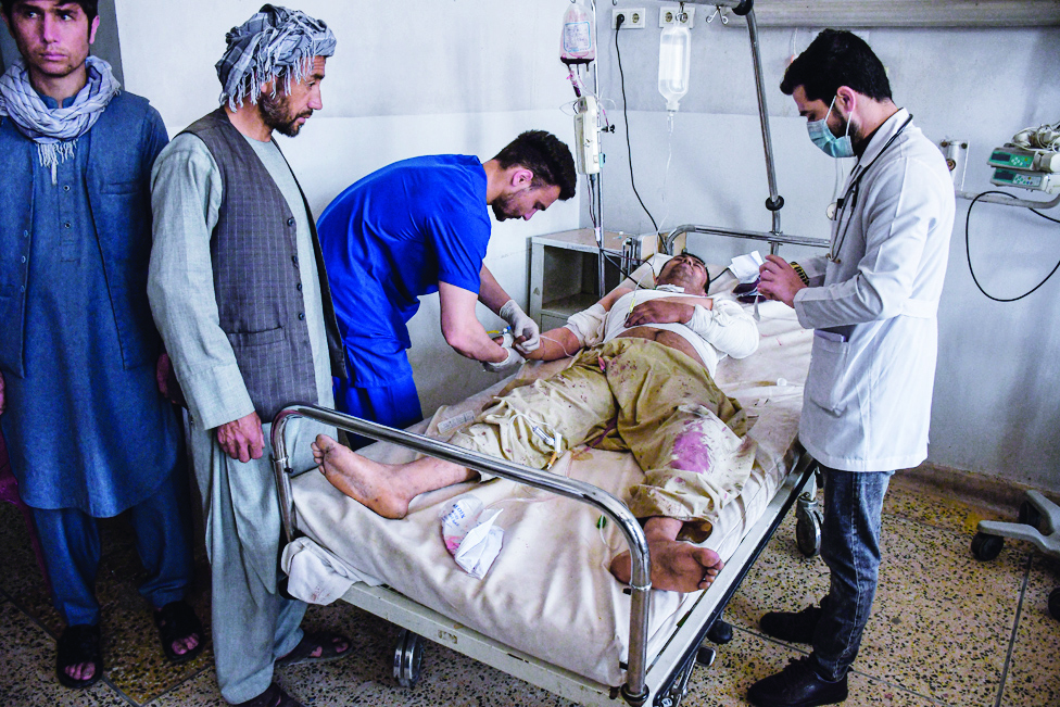 MAZAR-I-SHARIF: A wounded Afghan man receives treatment at a hospital after he got injured in a bomb blast at the Shiite Seh Dokan Mosque in Mazar-i-Sharif. - AFP