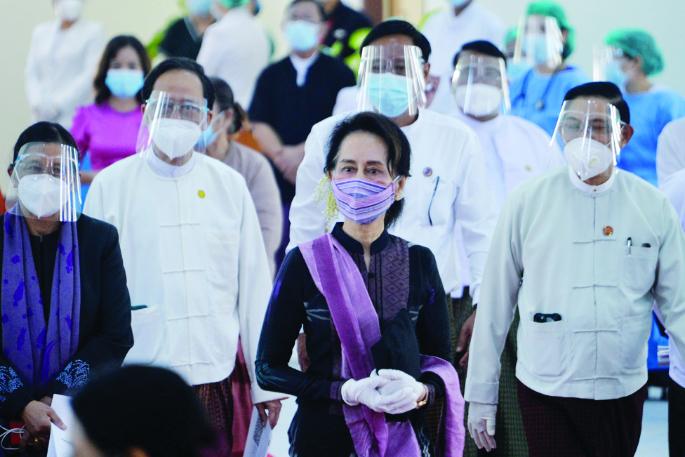 NAYPYIDAW: File photo shows Myanmar's State Counsellor Aung San Suu Kyi (C) looks on as health workers receive a vaccine for the COVID-19 coronavirus at a hospital in Naypyidaw. A Myanmar junta court found ousted Aung San Suu Kyi guilty of corruption and sentenced her to five years in prison. – AFP