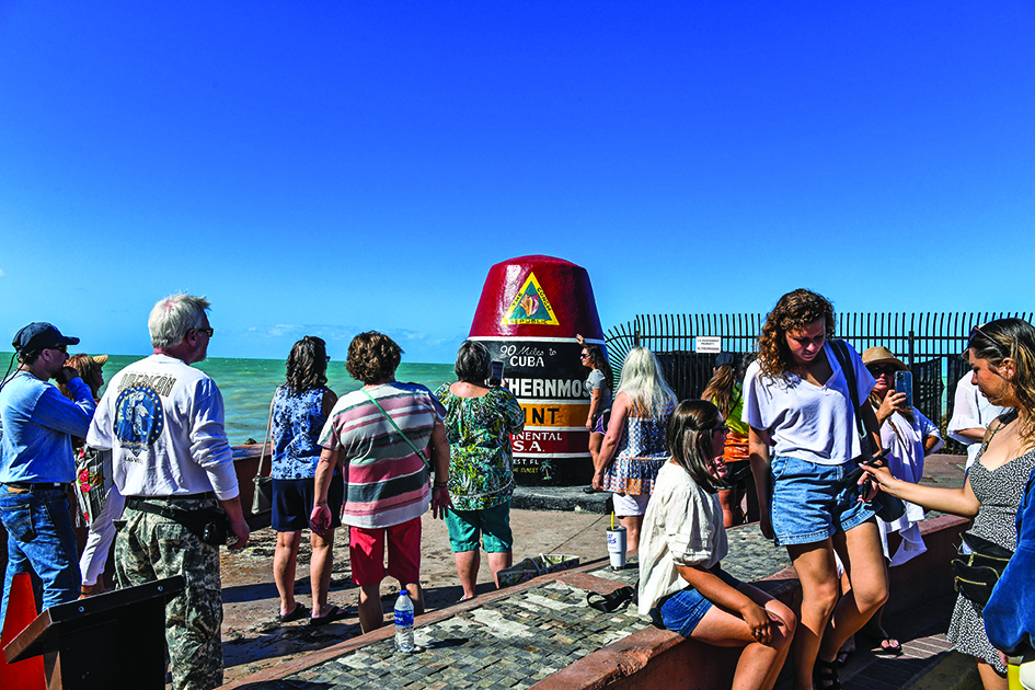 KEY WEST, US: Tourists wait at the Southernmost Point Buoy in Key West, Florida.—AFP