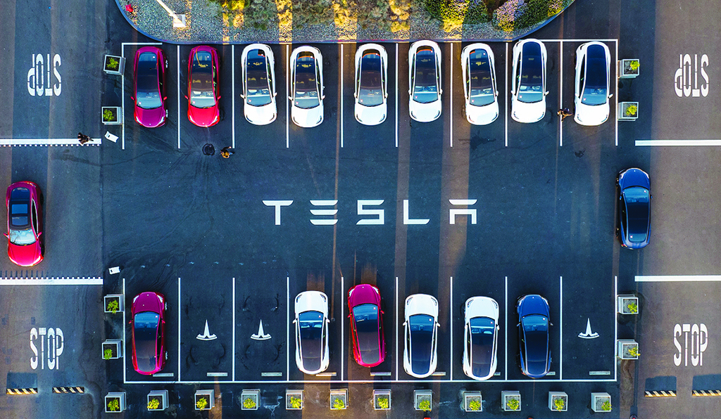 FREMONT, US: An aerial view of cars parked at the Tesla Fremont Factory in Fremont, California. US electric car manufacturer Tesla shipped a record number of more than one million cars over the past year, according to figures published April 2, 2022. - AFP