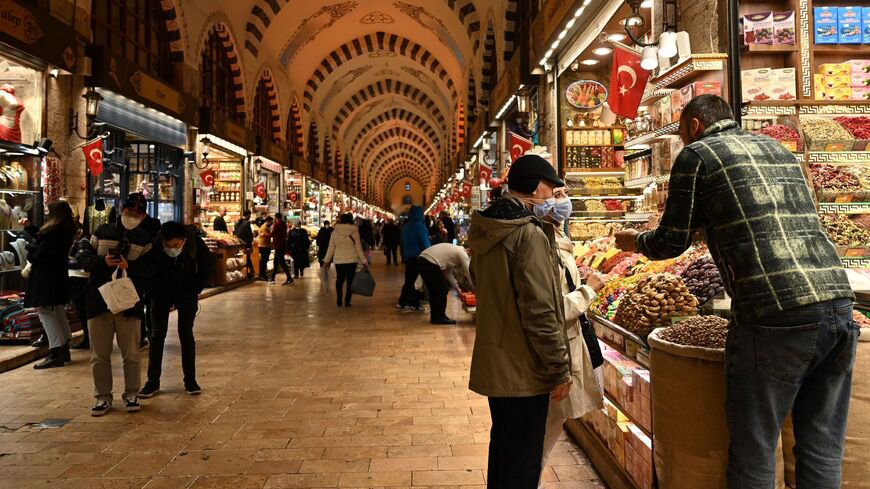 Tourists shop inside spice bazaar at Eminonu district in Istanbul .-AFP