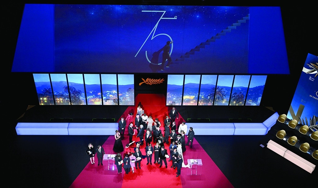 Swedish film director Ruben Ostlund (fourth right) poses on stage with his trophy, surrounded by fellow winners (from left) British director and screenwriter Gina Gammell, Chinese director Jianying Chen, South Korean director Park Chan-Wook, Polish director Jerzy Skolimowski, Swedish director Tarik Saleh, South Korean actor Song Kang-Ho, French actor and President of the Jury of the 75th Cannes Film Festival Vincent Lindon, Iranian actress Zar Amir-Ebrahimi and French film director Claire Denis at the end of the Closing Ceremony of the 75th edition of the Cannes Film Festival in Cannes, southern France.—AFP photos