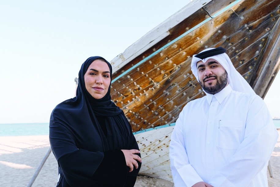 A handout picture released by Nefaish Animation studio shows creative director Amal Al-Shammari (left) and managing director Hossein Heydar pose for a picture in the capital Doha. - AFP