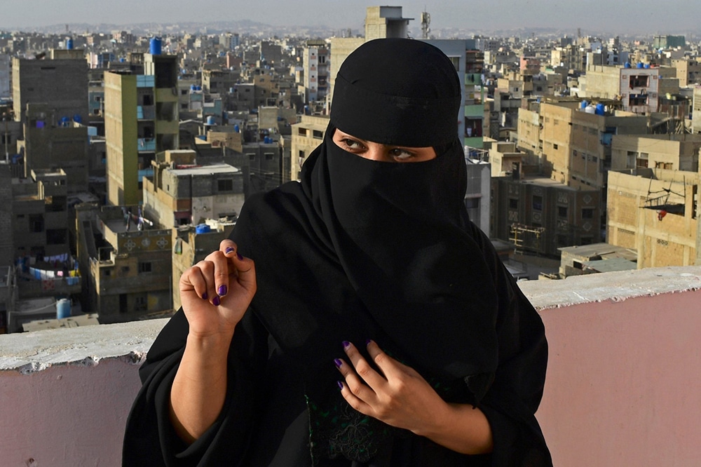 In this picture taken March 9, 2022, rapper Eva B gestures during an interview with AFP on the rooftop of a building in Lyari district in Karachi. Pakistan's breakthrough rapper Eva B has racked up millions of views online, but walking through the labyrinthine streets of her Karachi neighbourhood, she is anonymous.  — AFP
