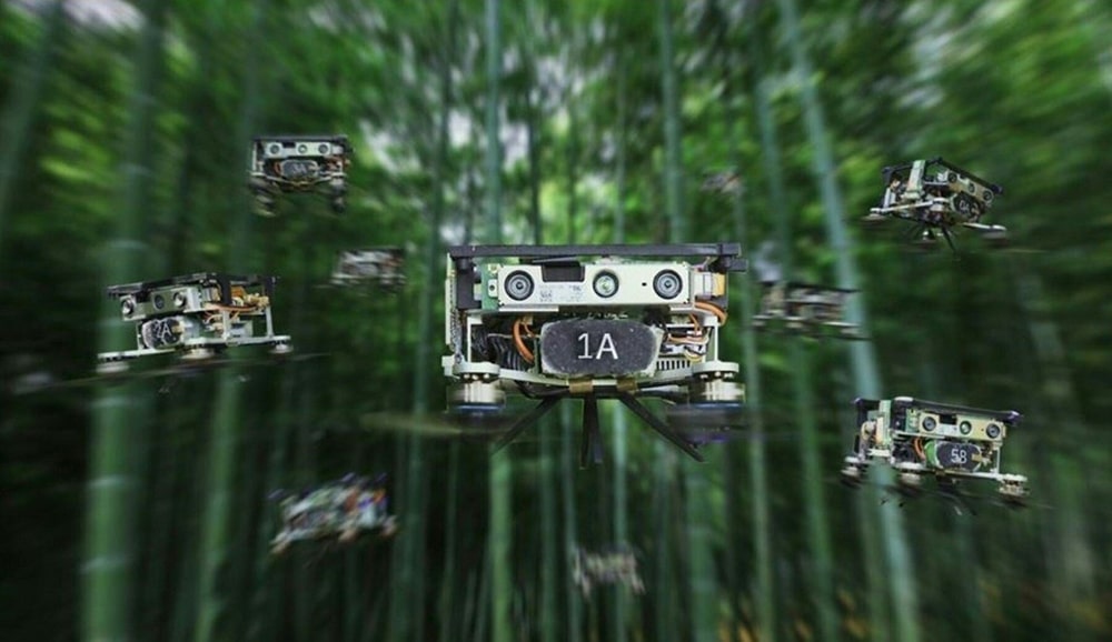 This Handout photo provided by Yuman Gao and Rui Jin on May 4, 2022 shows a new flight path planning system enables drone swarms to fly through crowded forests without collisions. A dense bamboo forest, China. Suddenly, ten small blue drones the size of a palm of a hand rise in a buzz. — AFP