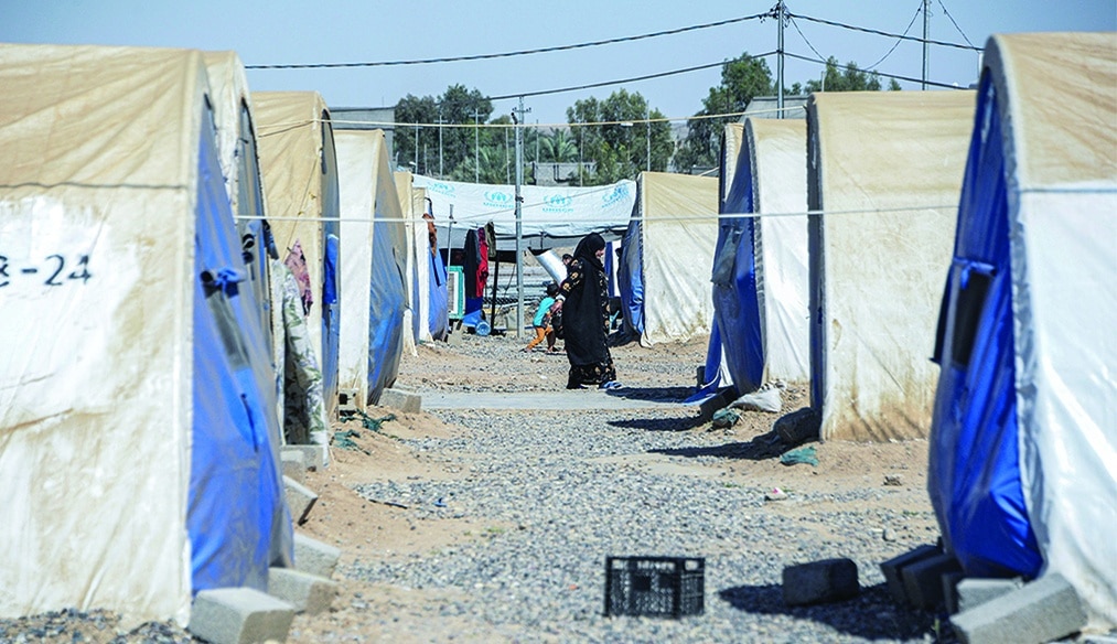 AL-JADAA, Iraq: A woman walks near her tent at the Jadaa rehabilitation camp for the displaced near the northern Iraqi city of Mosul. About 30,000 Iraqis, including 20,000 children, are still in northeastern Syria, in camps where refugees and displaced live alongside families connected to the Islamic State (IS) group.- AFP
