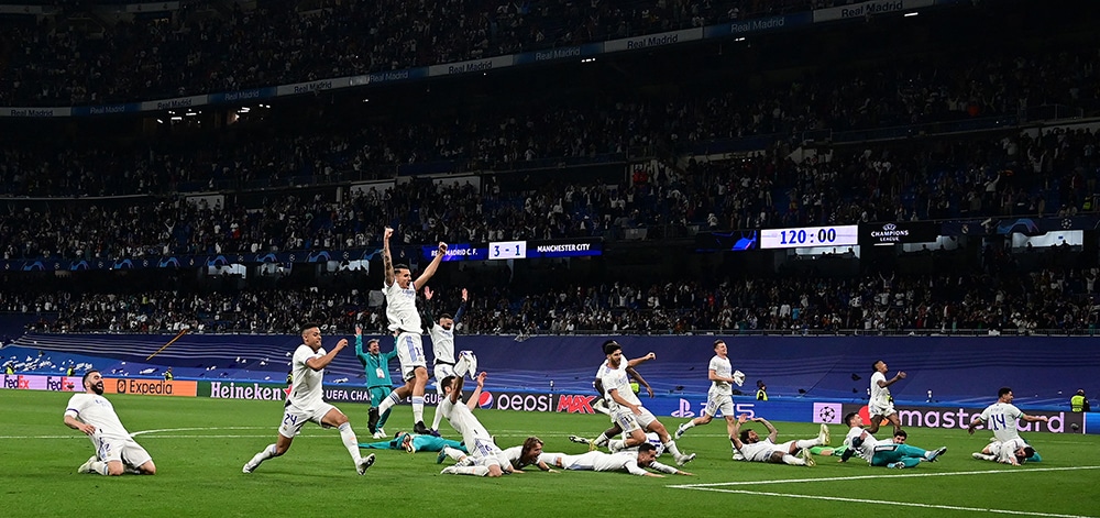 MADRID:  Real Madrid players celebrate wining the UEFA Champions League semi-final second leg football match between Real Madrid CF and Manchester City at the Santiago Bernabeu stadium in Madrid on May 4, 2022. Real Madrid won the match 3-1. - AFP