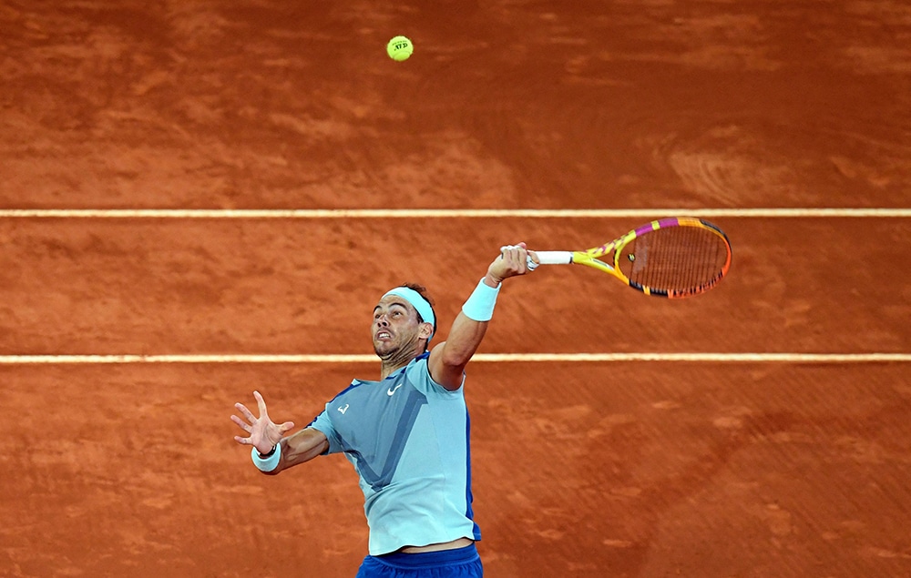MADRID: Spain's Rafael Nadal serves to Serbia's Miomir Kecmanovic during their 2022 ATP Tour Madrid Open tennis tournament singles match at the Caja Magica in Madrid on May 4, 2022. - AFP