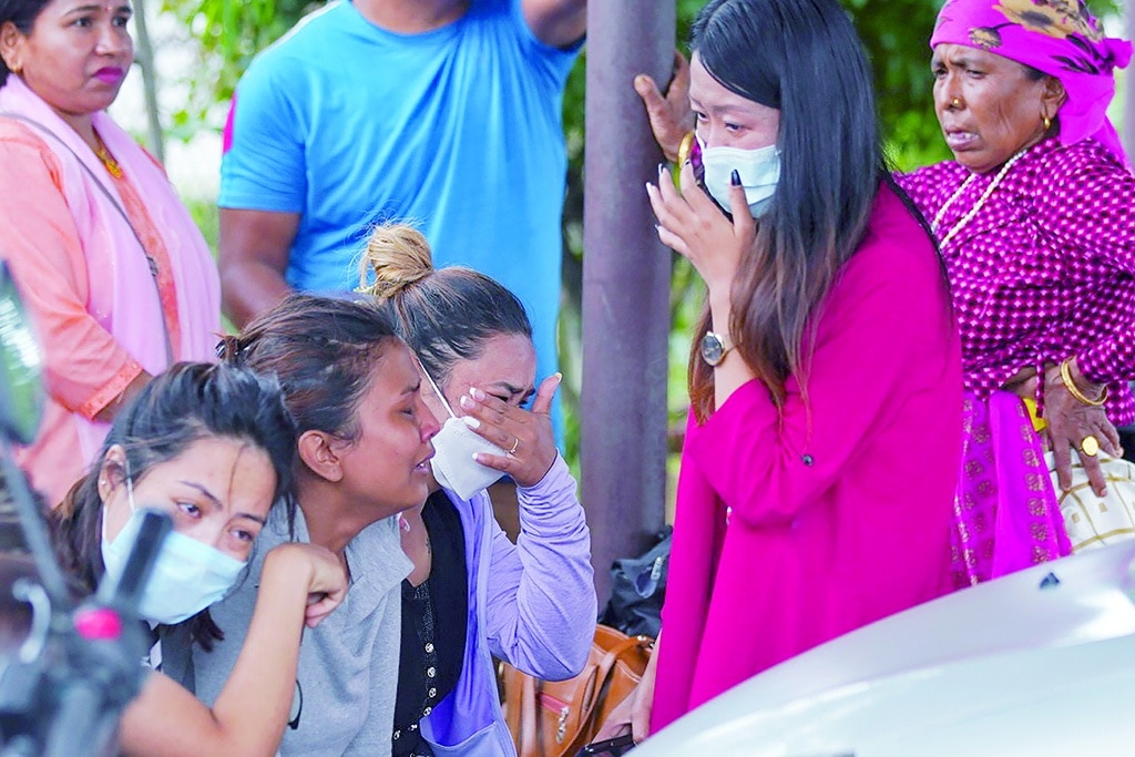 POKHARA, Nepal: Family members and relatives of passengers on board the Twin Otter aircraft operated by Tara Air, weep outside the airport in Pokhara on May 29, 2022. - AFP