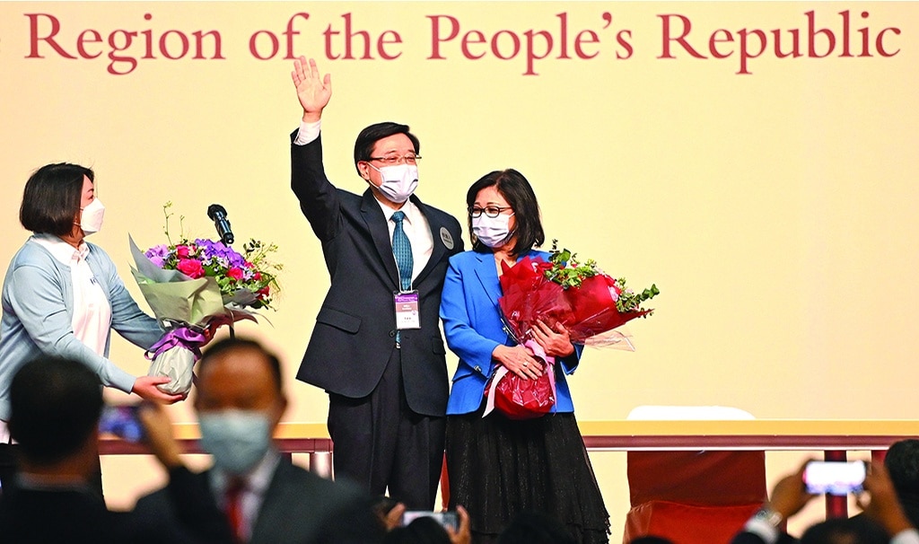 HONG KONG: John Lee (C) celebrates with his wife Janet (R) after he was named as the city's new leader in Hong Kong on May 8, 2022. John Lee, the former security chief who oversaw the crackdown on Hong Kong's democracy movement, was declared the business hub's new leader by a small committee of Beijing loyalists. – AFP