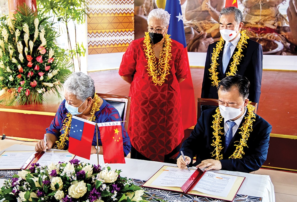 APIA, Samoa: Picture shows CEO of the Ministry of Foreign Affairs and Trade Peseta Noumea Simi (L) and China’s Ambassador to Samoa Chao Xiaoliang signing one of the bilateral agreements as Chinese Foreign Minister Wang Yi (back row R) and Samoa Prime Minister Fiame Naomi Mataafa look on during agreements signing ceremony. — AFP