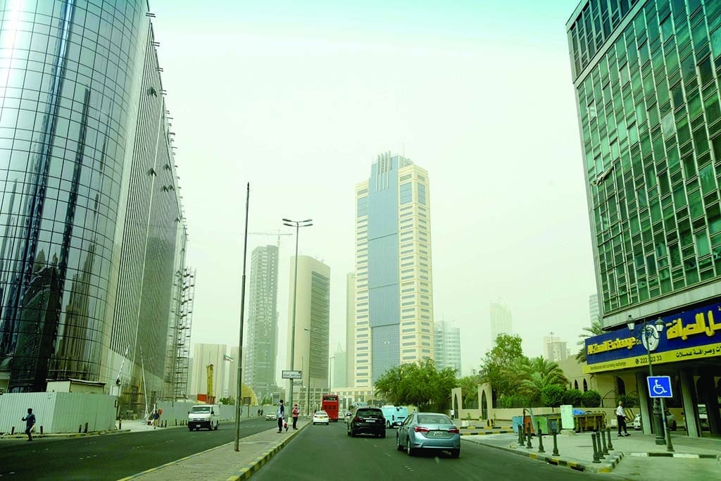 KUWAIT: Vehicles drive on a main street in Kuwait City Monday afternoon as traces of a dust storm that hit Kuwait a day earlier can still be seen. - Photo by Fouad Al-Shaikh