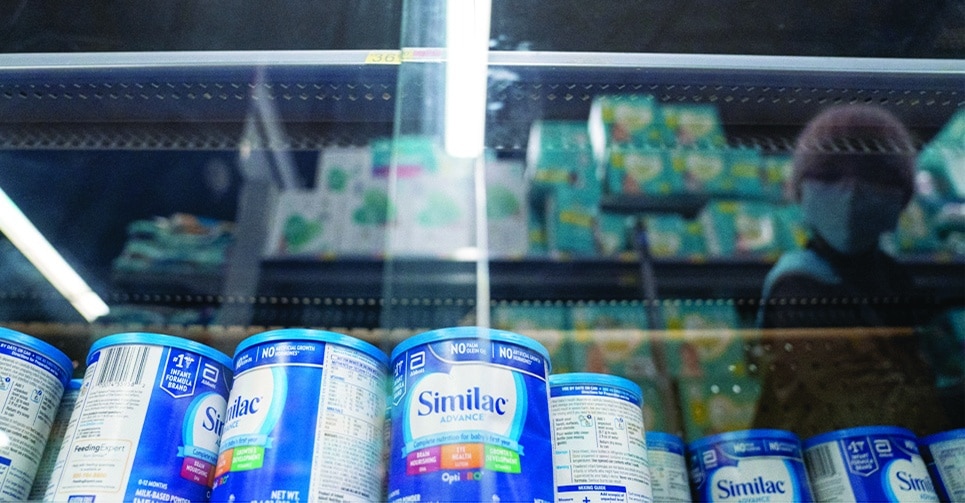 WASHINGTON: A shopper is reflected in a glass case while looking at baby formula at a grocery store in Washington, DC, on May 11, 2022. – AFP